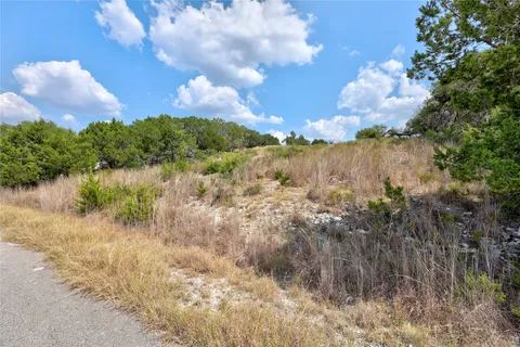 a view of lake with houses in the background