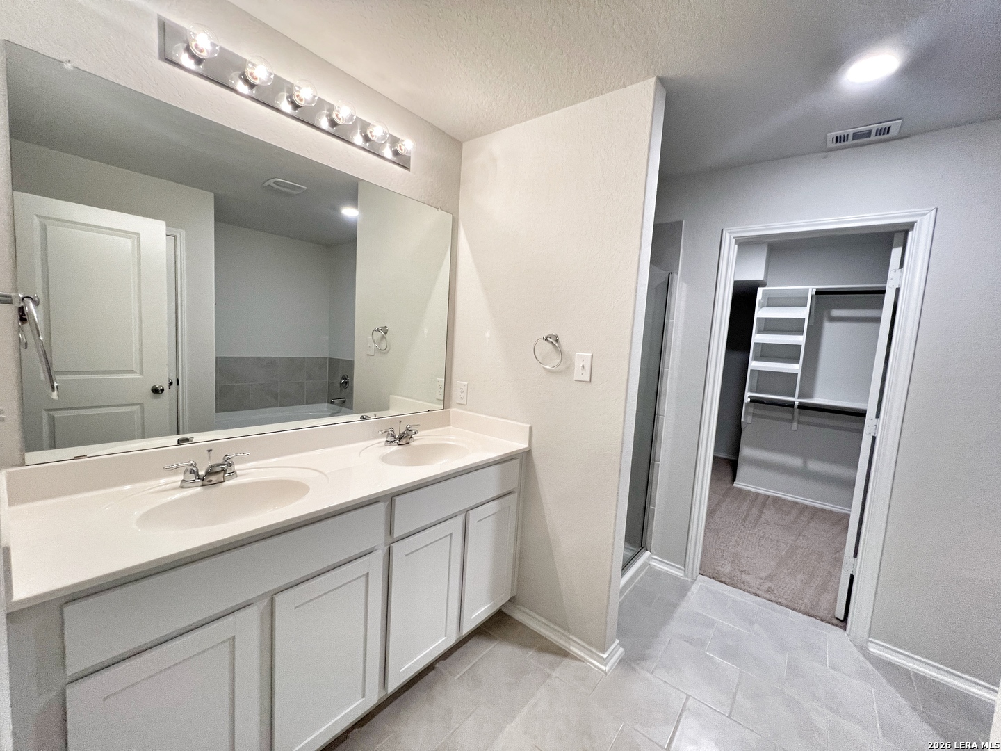 29529 Spring Copper Bulverde, TX 78163 - Photo 35 of 41 a bathroom with a double vanity sink and mirror