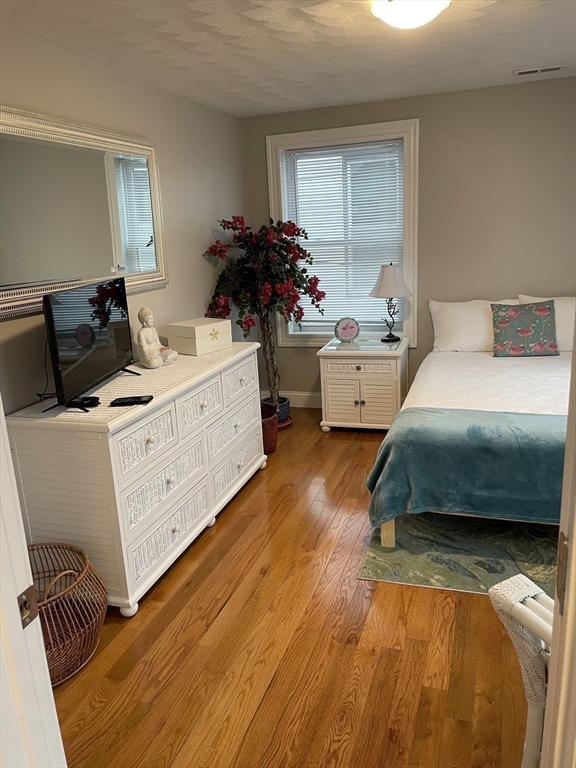 13 High Street, Unit 2 Amesbury, MA 01913 - Photo 13 of 16 a room with a bed and a dresser