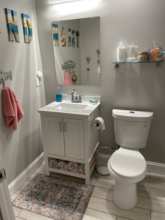 13 High Street, Unit 2 Amesbury, MA 01913 - Photo 14 of 16 a white toilet sitting next to a bathroom sink