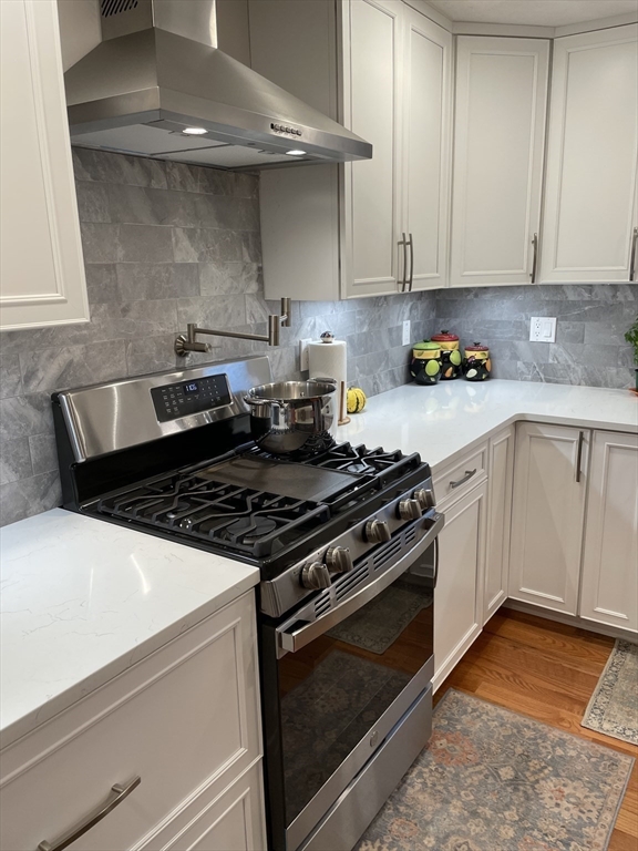 13 High Street, Unit 2 Amesbury, MA 01913 - Photo 5 of 16 a white stove top oven sitting inside of a kitchen