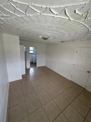 a view of a livingroom with an empty space and a sink