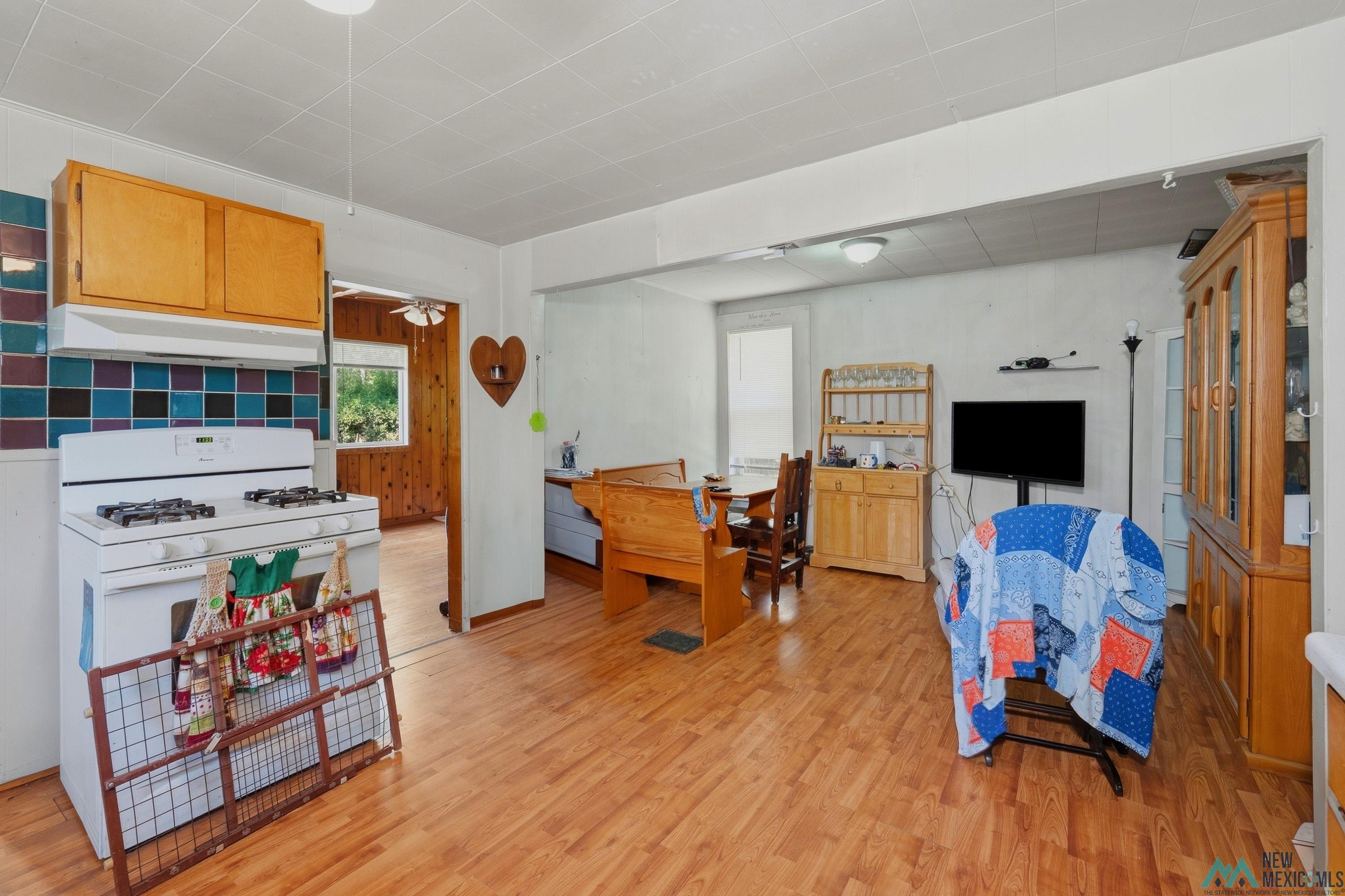 811 North 4th Street Raton, NM 87740 - Photo 8 of 26 Kitchen and dining area featuring wood-finish flooring