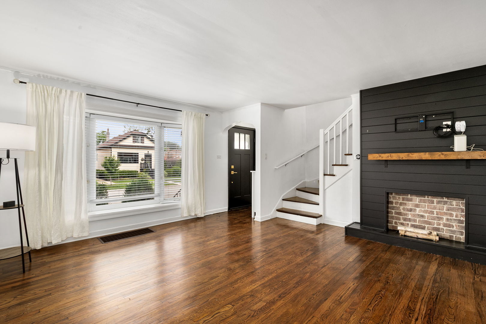 4237 Park Avenue Brookfield, IL 60513 - Photo 3 of 20 an empty room with wooden floor fireplace and windows