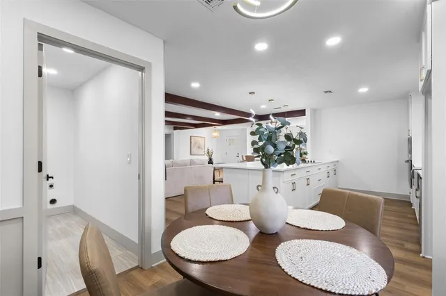 a dining room with furniture and wooden floor