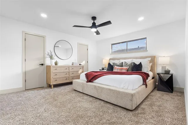 a bedroom with a bed and a ceiling fan
