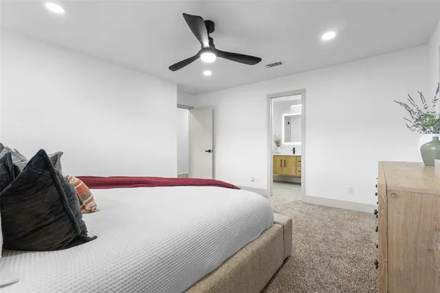 a spacious bathroom with a double vanity sink toilet and a mirror