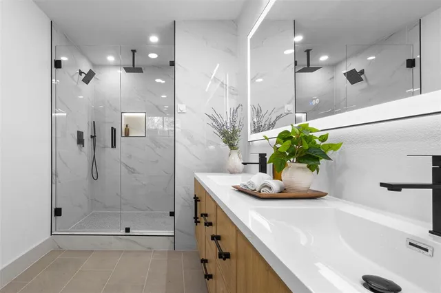 a bathroom with a sink a toilet and shower