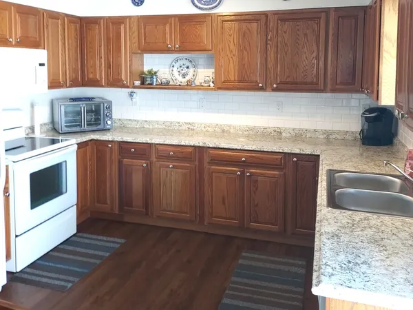 a kitchen with granite countertop a sink and a stove