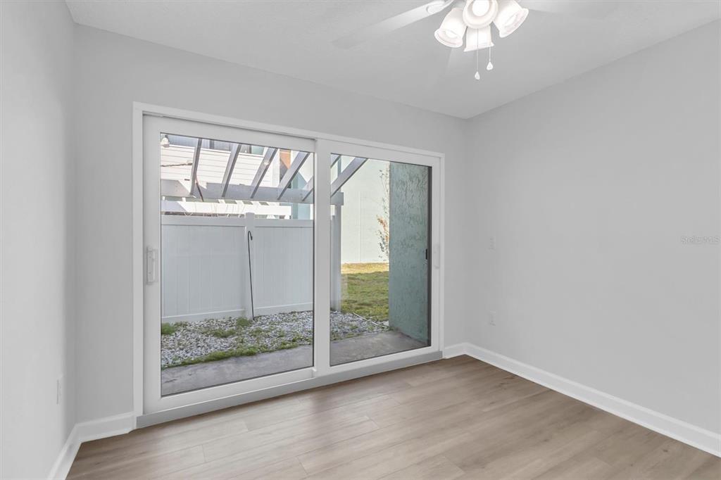 1 Windrush Boulevard, Unit 87 Indian Rocks Beach, FL 33785 - Photo 11 of 54 an empty room with wooden floor and windows