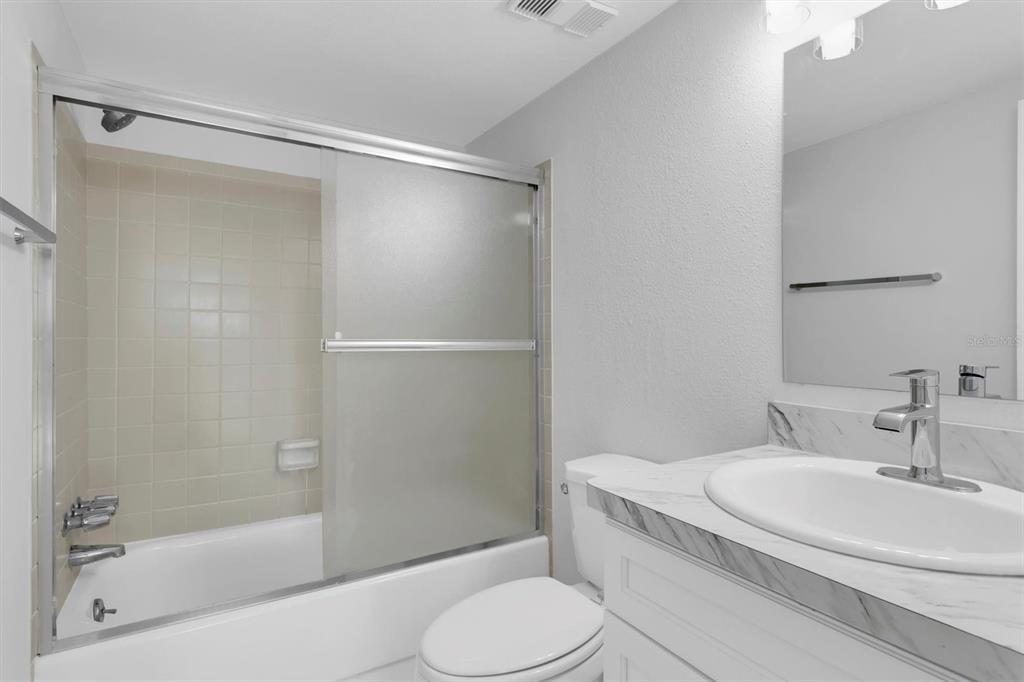 1 Windrush Boulevard, Unit 87 Indian Rocks Beach, FL 33785 - Photo 16 of 54 a bathroom with a sink toilet and shower