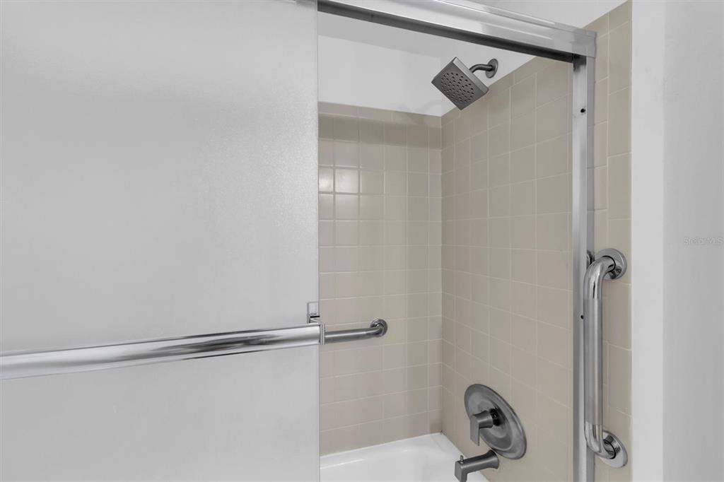 1 Windrush Boulevard, Unit 87 Indian Rocks Beach, FL 33785 - Photo 17 of 54 a bathroom that has a shower in it