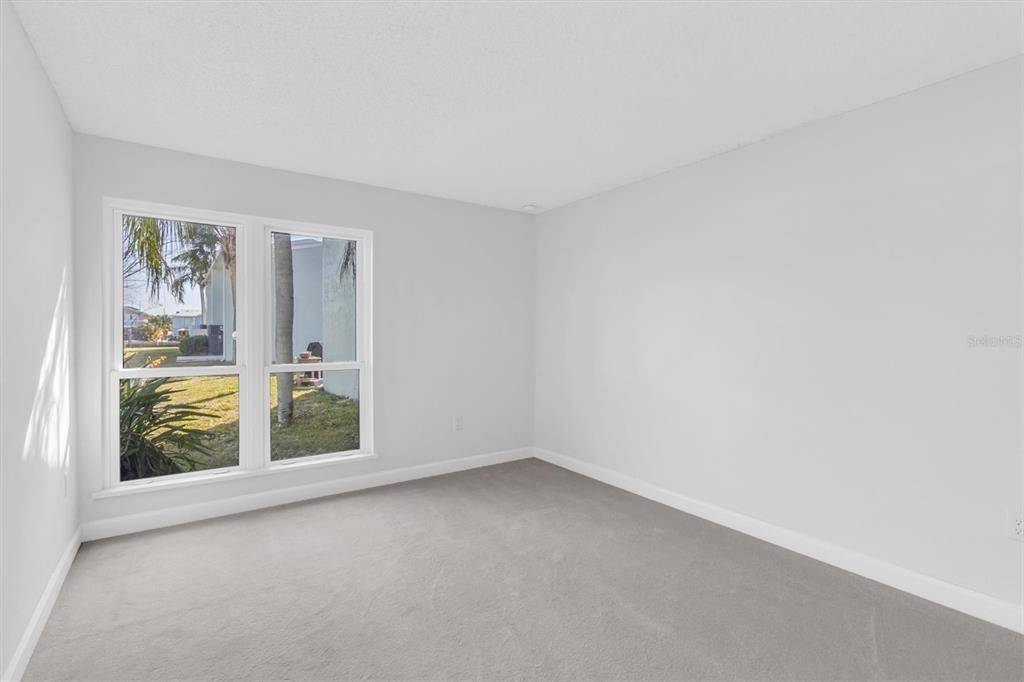 1 Windrush Boulevard, Unit 87 Indian Rocks Beach, FL 33785 - Photo 18 of 54 an empty room with windows