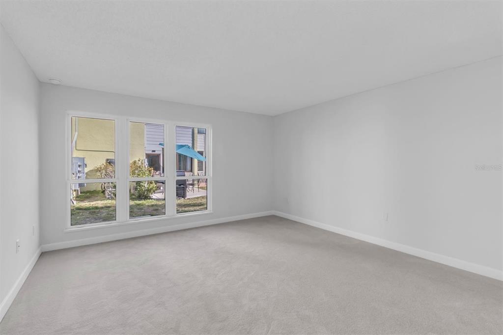 1 Windrush Boulevard, Unit 87 Indian Rocks Beach, FL 33785 - Photo 23 of 54 an empty room with windows