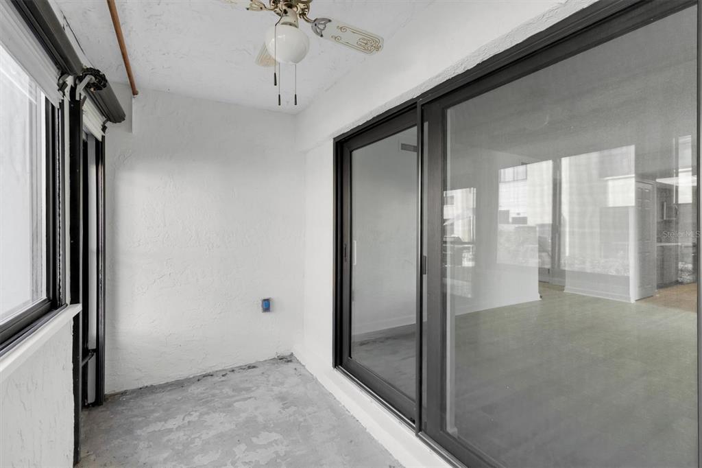 1 Windrush Boulevard, Unit 87 Indian Rocks Beach, FL 33785 - Photo 26 of 54 a view of a hallway with a chandelier