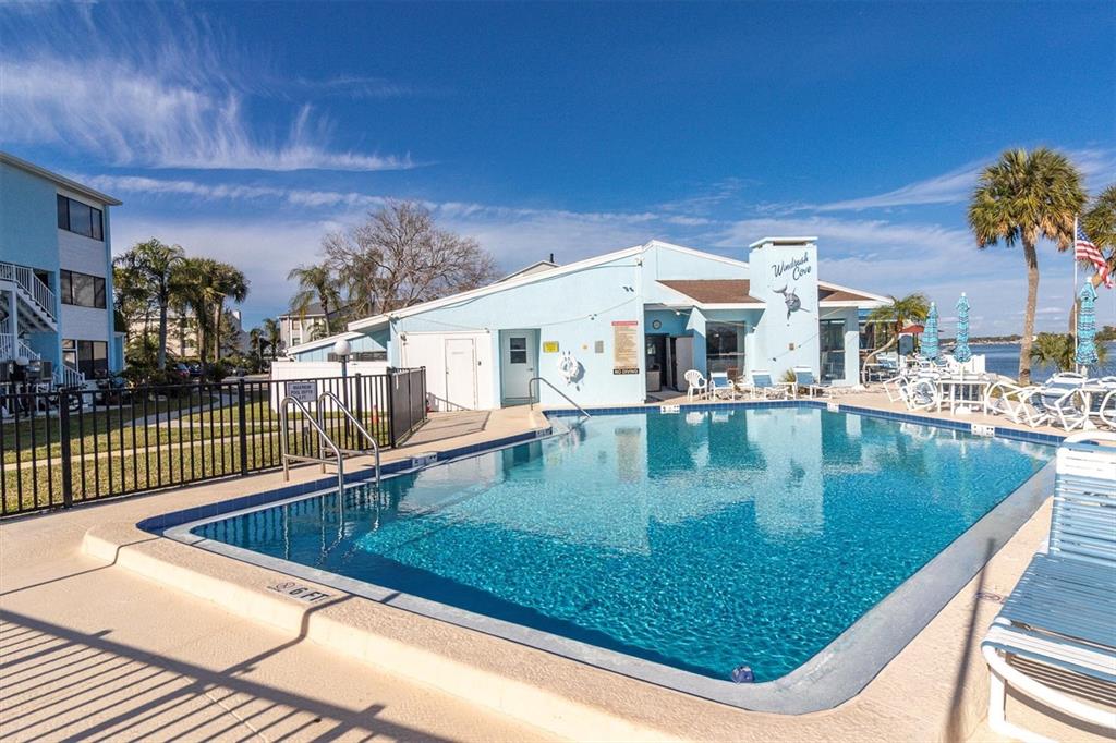 1 Windrush Boulevard, Unit 87 Indian Rocks Beach, FL 33785 - Photo 37 of 54 a view of a swimming pool with a patio