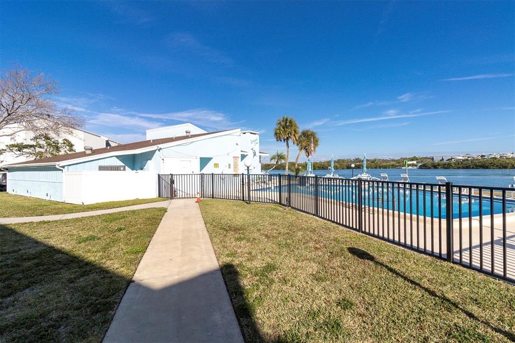 1 Windrush Boulevard, Unit 87 Indian Rocks Beach, FL 33785 - Photo 38 of 54 a view of a swimming pool with a yard