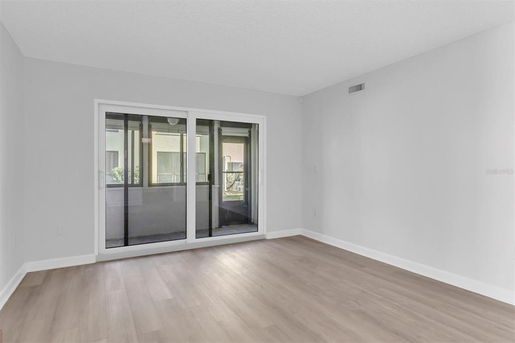 1 Windrush Boulevard, Unit 87 Indian Rocks Beach, FL 33785 - Photo 4 of 54 wooden floor in an empty room