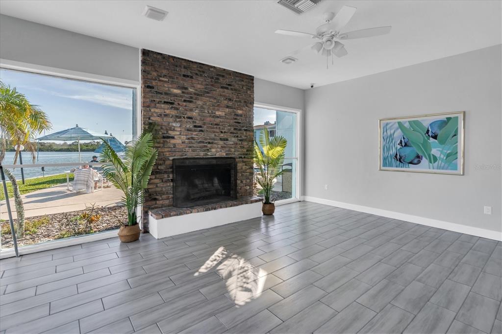 1 Windrush Boulevard, Unit 87 Indian Rocks Beach, FL 33785 - Photo 46 of 54 a living room with furniture and a fireplace