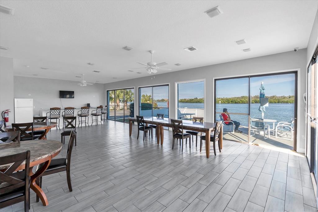 1 Windrush Boulevard, Unit 87 Indian Rocks Beach, FL 33785 - Photo 47 of 54 a dining room with furniture window and wooden floor