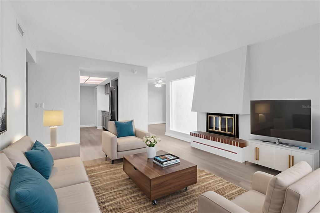 1 Windrush Boulevard, Unit 87 Indian Rocks Beach, FL 33785 - Photo 5 of 54 a living room with furniture and a flat screen tv