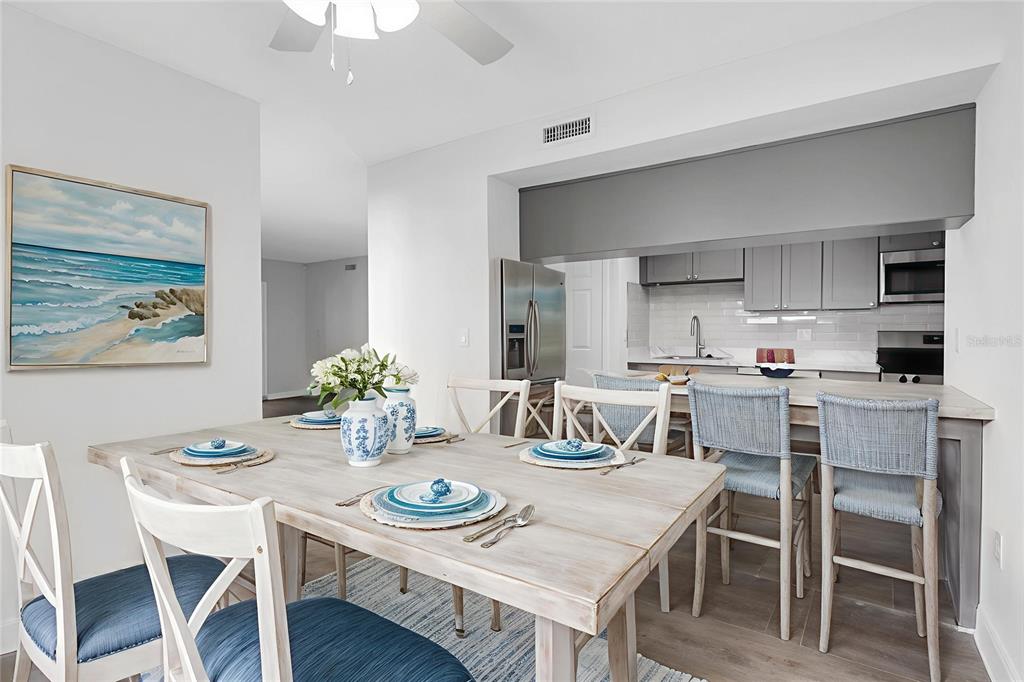 1 Windrush Boulevard, Unit 87 Indian Rocks Beach, FL 33785 - Photo 7 of 54 a view of a dining room with furniture and wooden floor