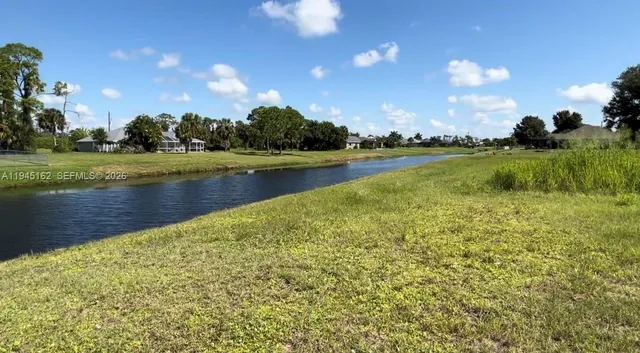 a view of a lake with houses in the background