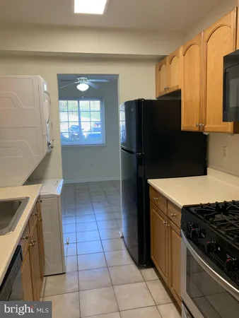 a kitchen with a wooden cabinets and a stove top oven