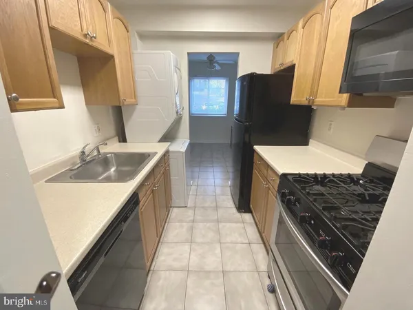 a kitchen with a sink stove and refrigerator