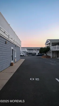 a view of a house with wooden deck and furniture
