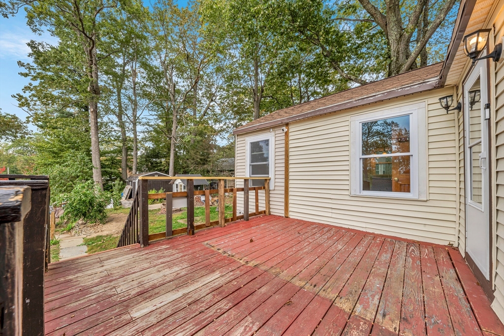 4 Stevens Way Rutland, MA 01543 - Photo 10 of 42 a view of a deck with wooden floor and fence next to a yard
