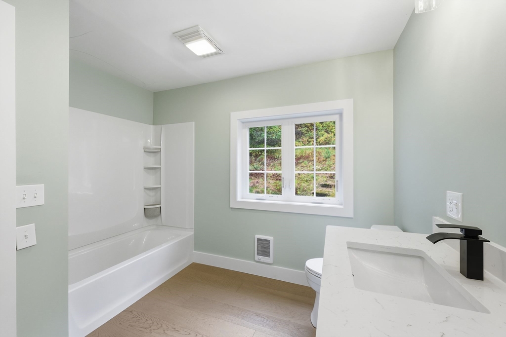 75 Lead Mine Road Southampton, MA 01073 - Photo 21 of 42 a bathroom with a tub sink and a window