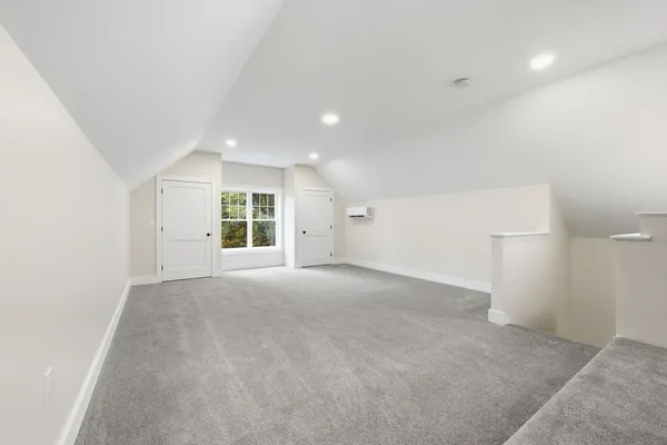 a view of a big room with windows and chandelier fan