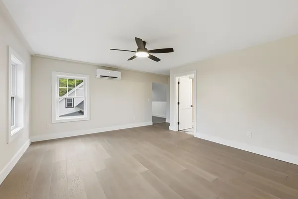 wooden floor in an empty room with a window
