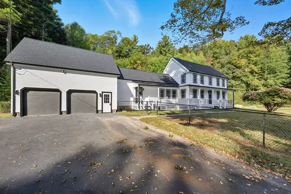 a house that has a large pool in front of it