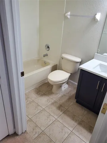 a bathroom with a toilet a sink and bathtub