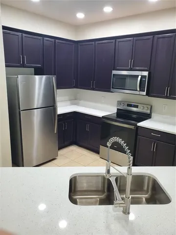 a kitchen with kitchen island stainless steel appliances a counter top space