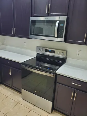 a kitchen with a stove microwave and sink
