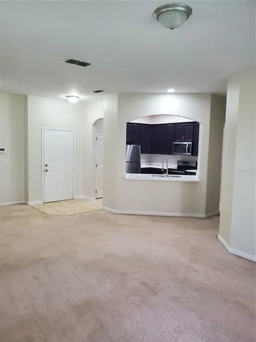 a view of empty room with a fireplace