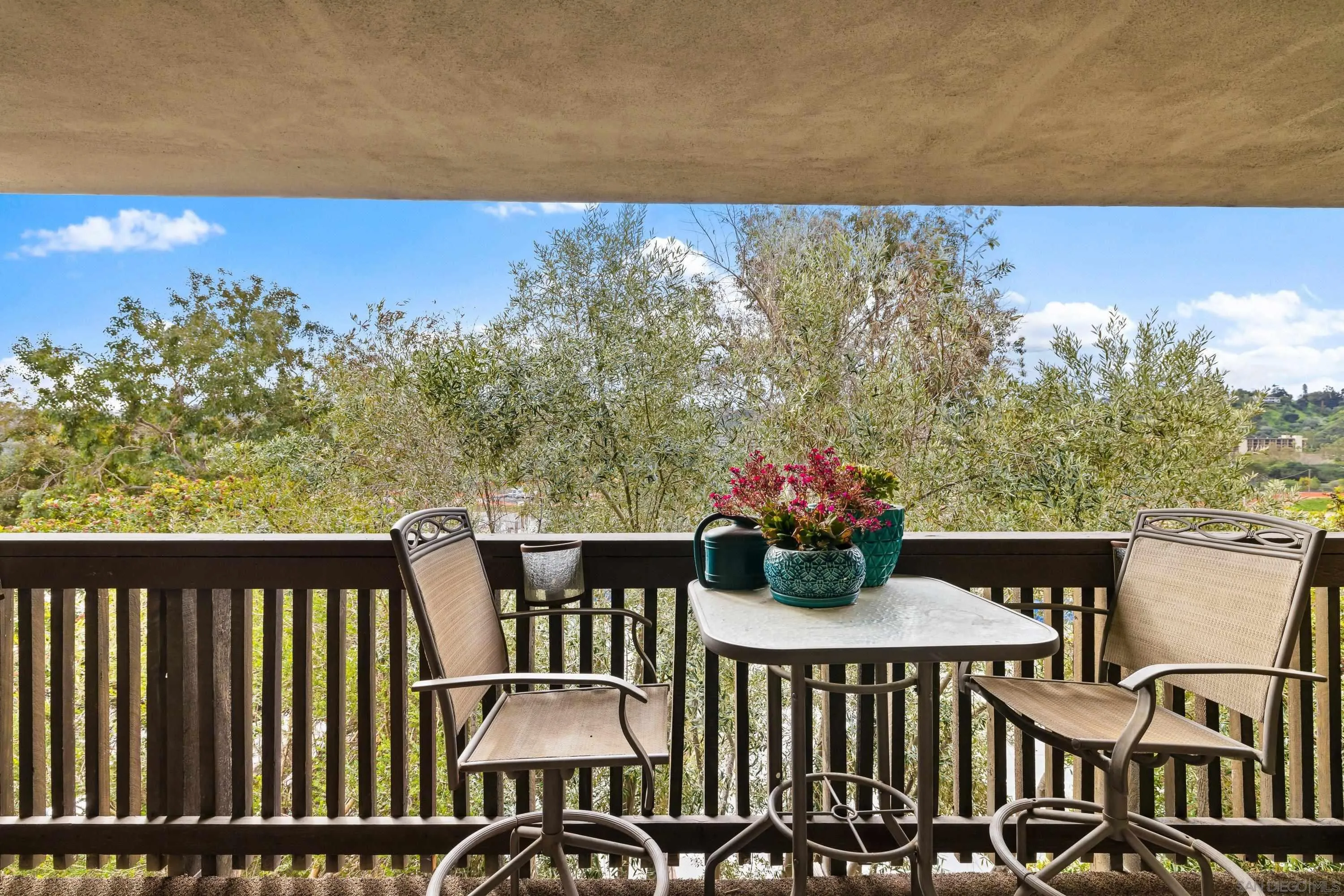 a view of a chairs and table on the roof deck