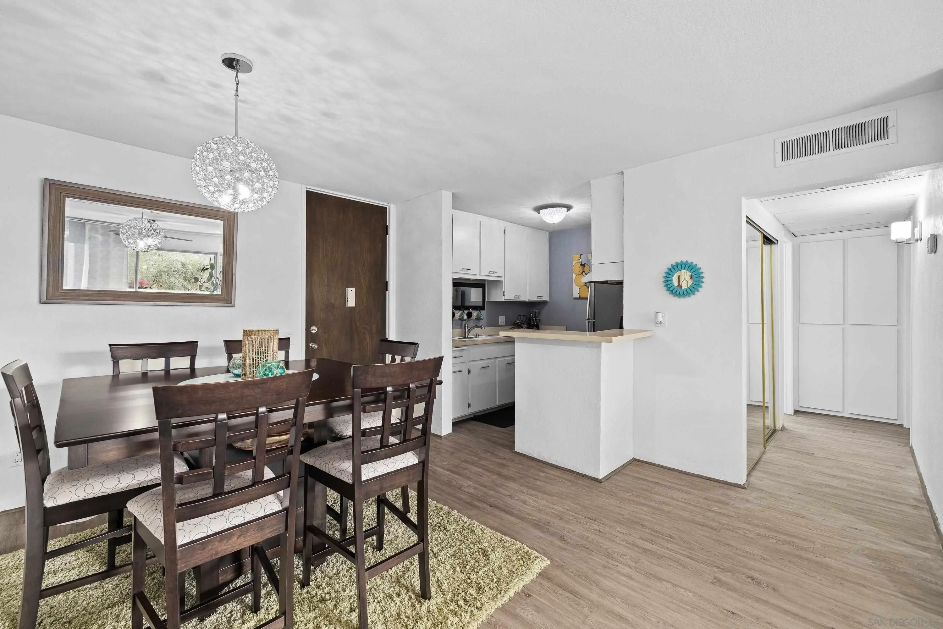 6406 Friars Road, Unit 338 San Diego, CA 92108 - Photo 17 of 36 a view of a dining room with furniture and wooden floor