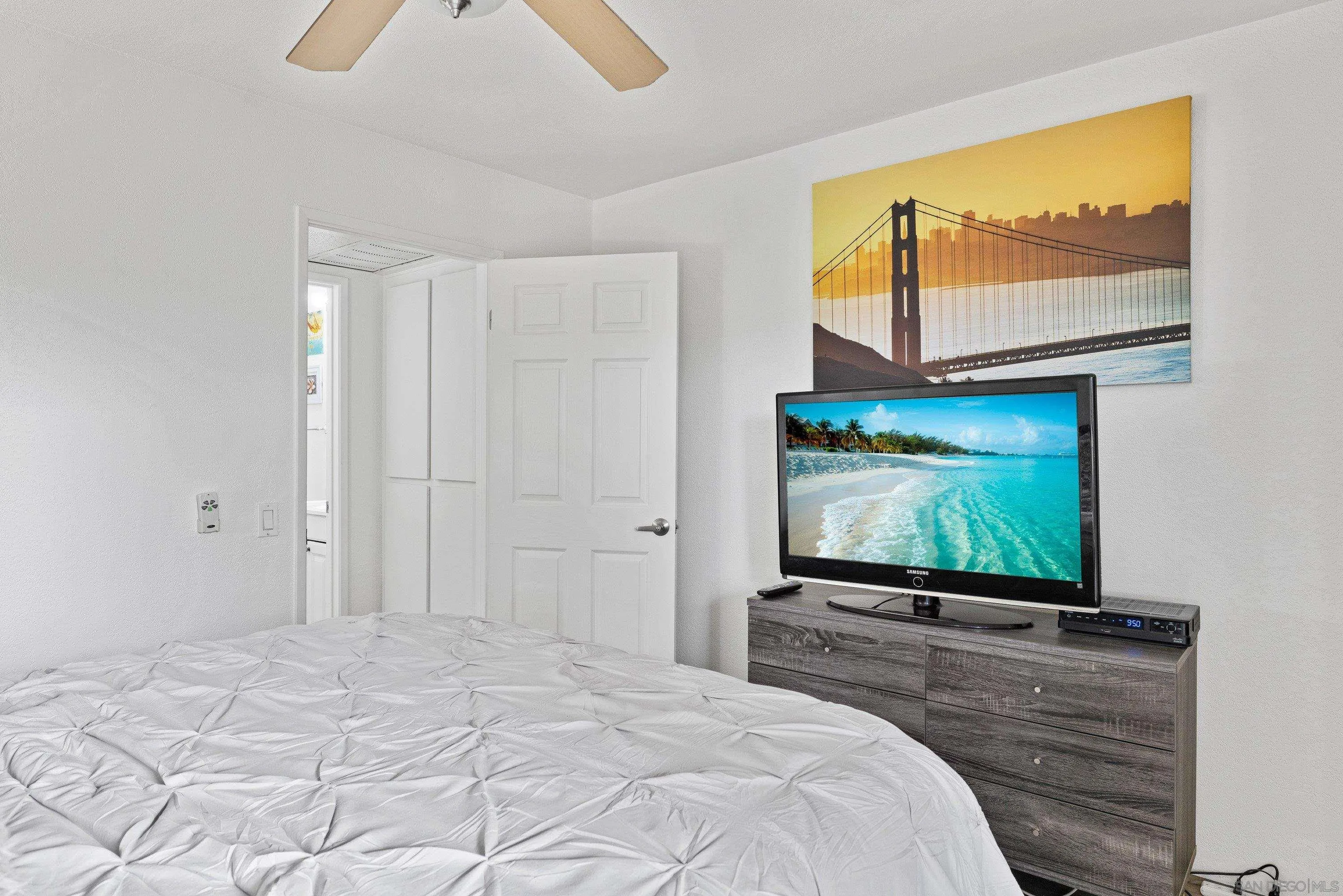 6406 Friars Road, Unit 338 San Diego, CA 92108 - Photo 23 of 36 a bedroom with a bed and a flat screen tv