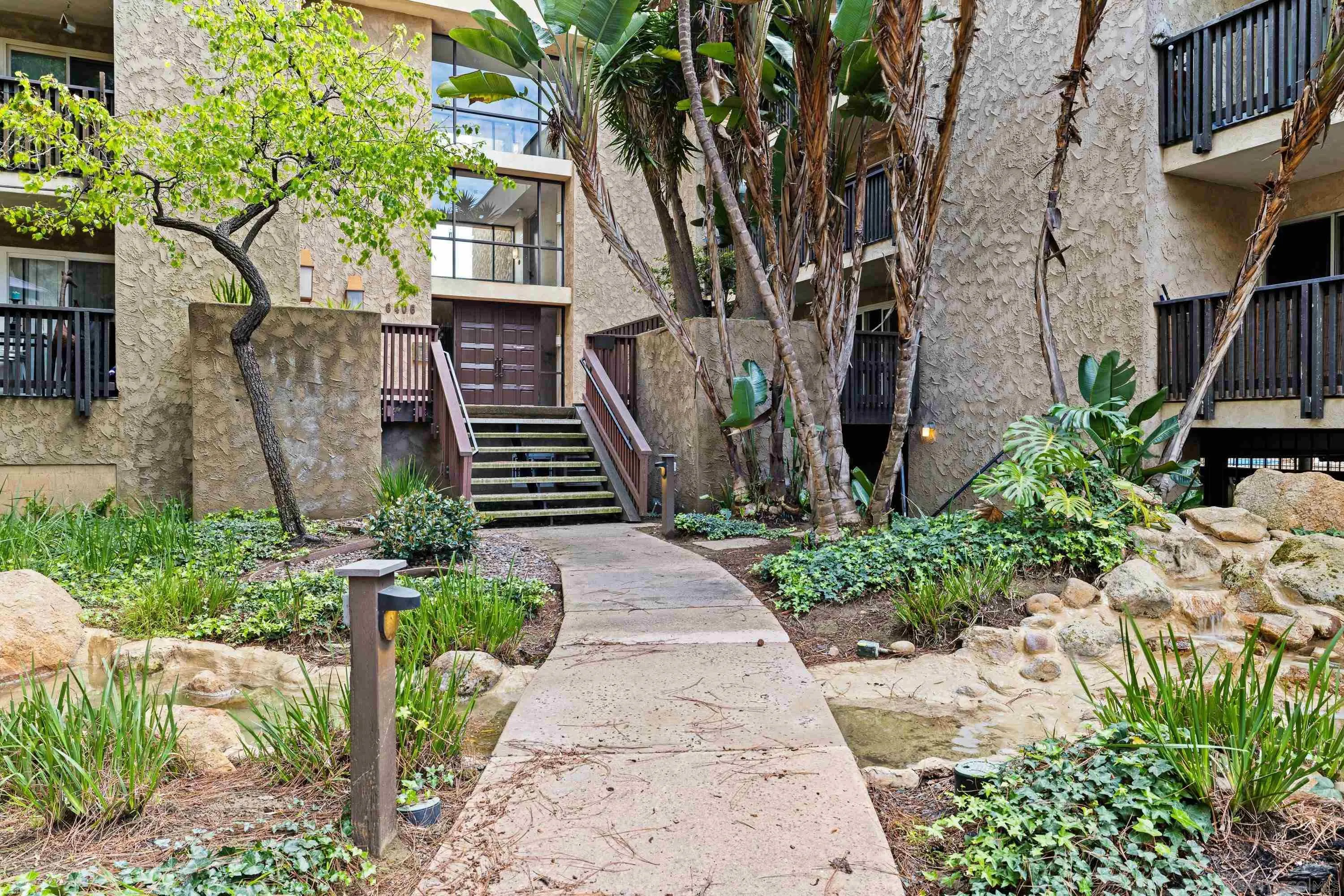 6406 Friars Road, Unit 338 San Diego, CA 92108 - Photo 26 of 36 a front view of a house with a garden