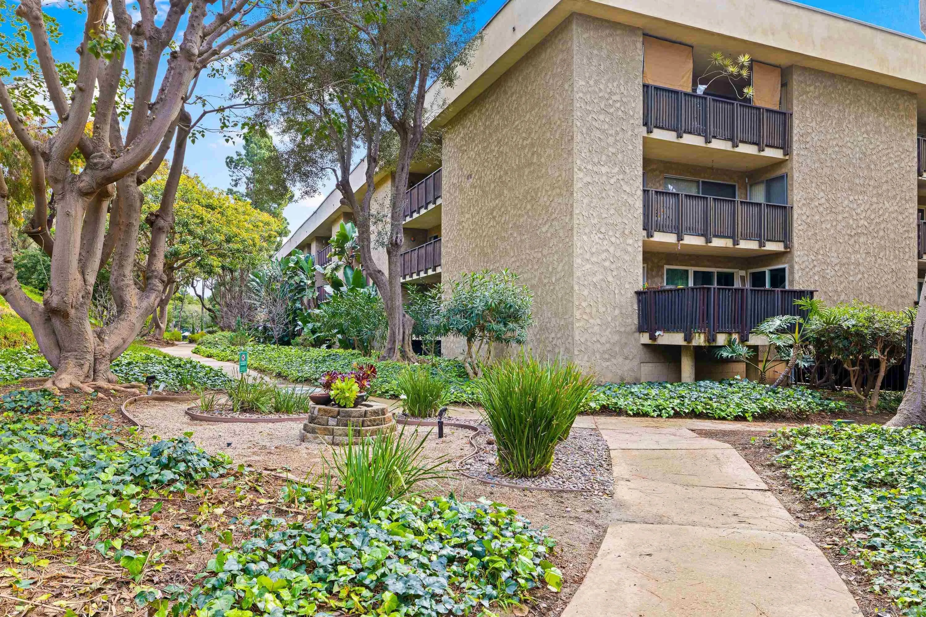 6406 Friars Road, Unit 338 San Diego, CA 92108 - Photo 27 of 36 a view of a building with a yard and sitting area