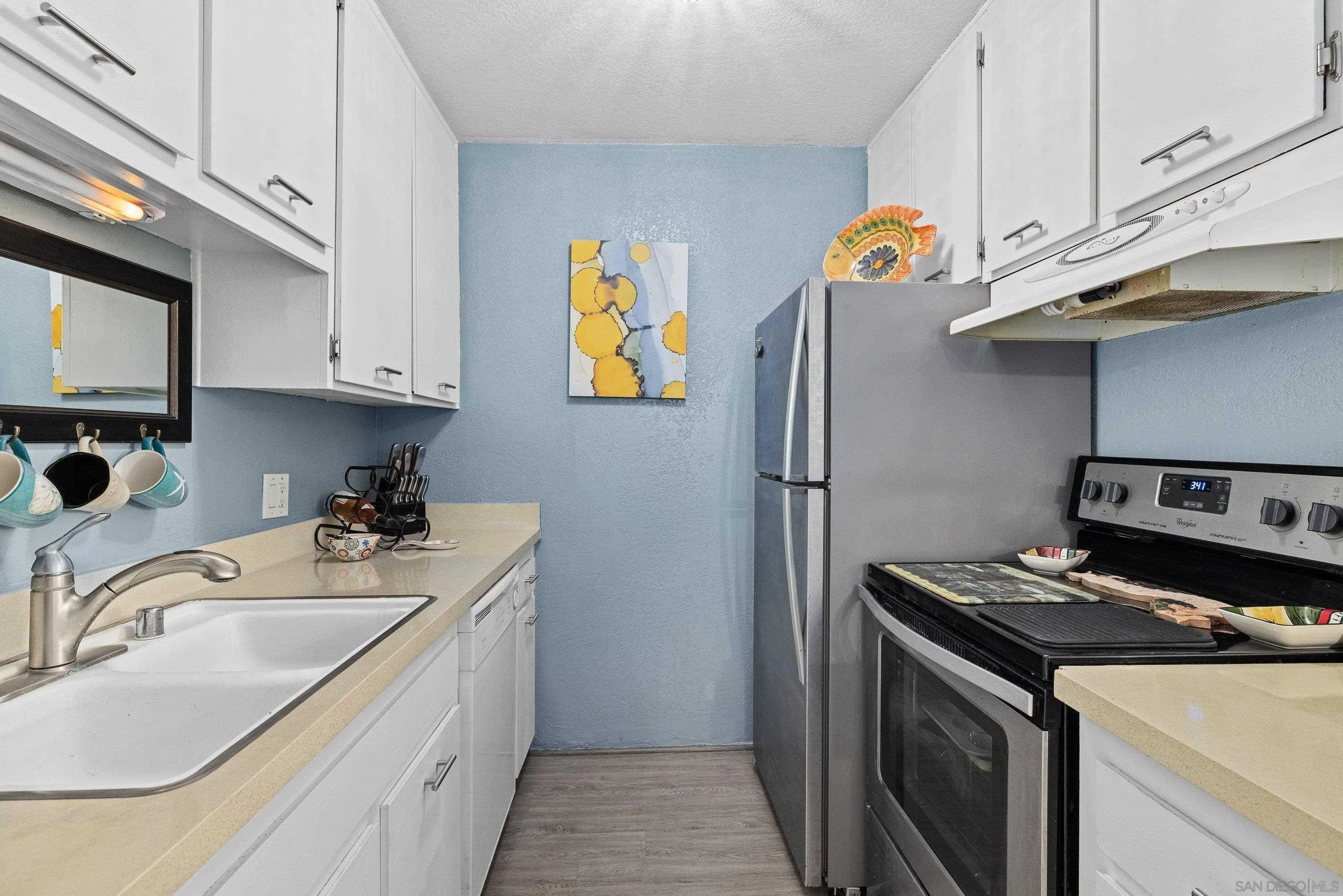 6406 Friars Road, Unit 338 San Diego, CA 92108 - Photo 6 of 36 a kitchen with stainless steel appliances granite countertop a sink stove and refrigerator