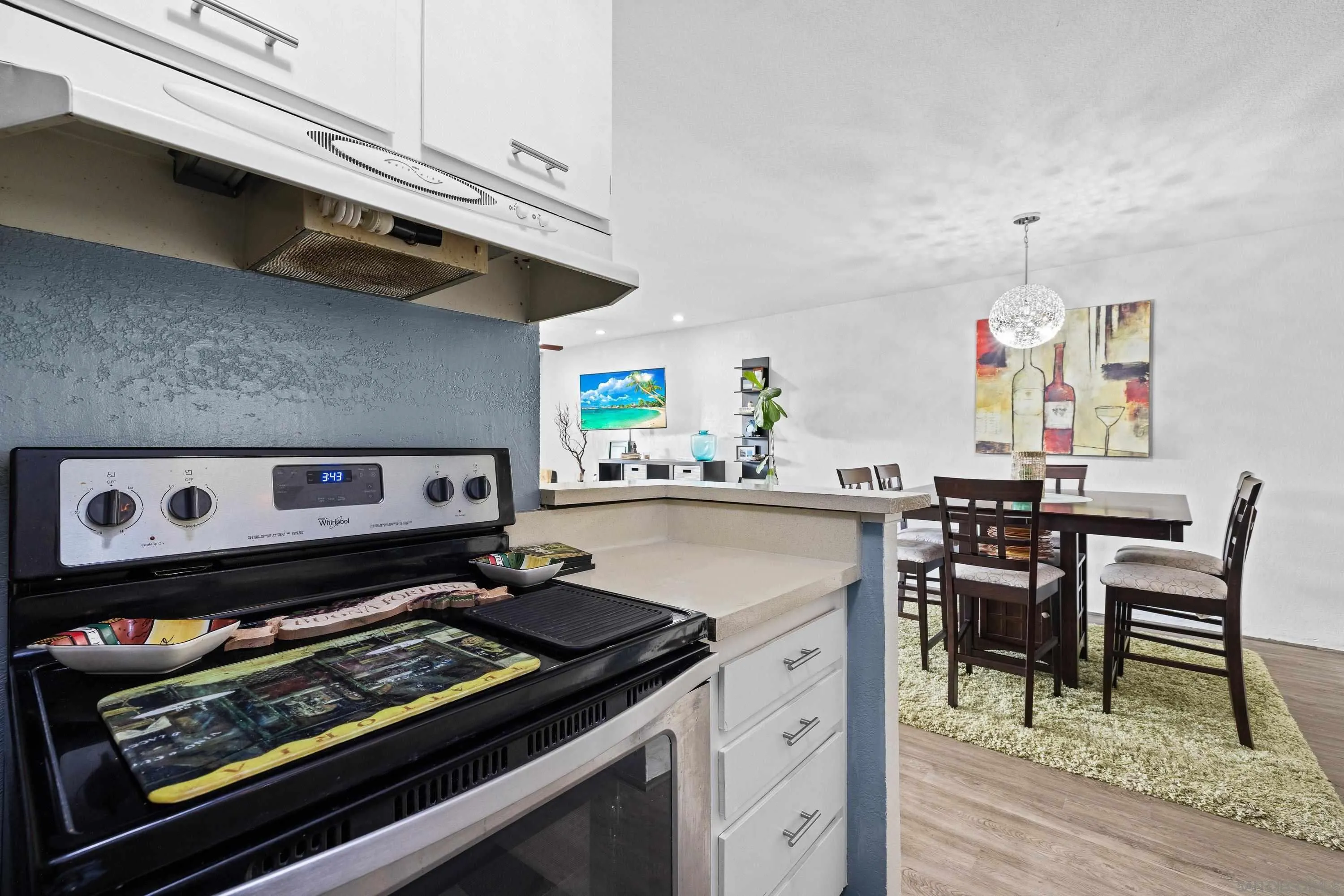 6406 Friars Road, Unit 338 San Diego, CA 92108 - Photo 7 of 36 a kitchen with a stove and a dining table