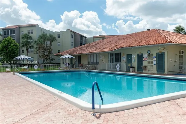 a view of a house with a swimming pool and sitting area