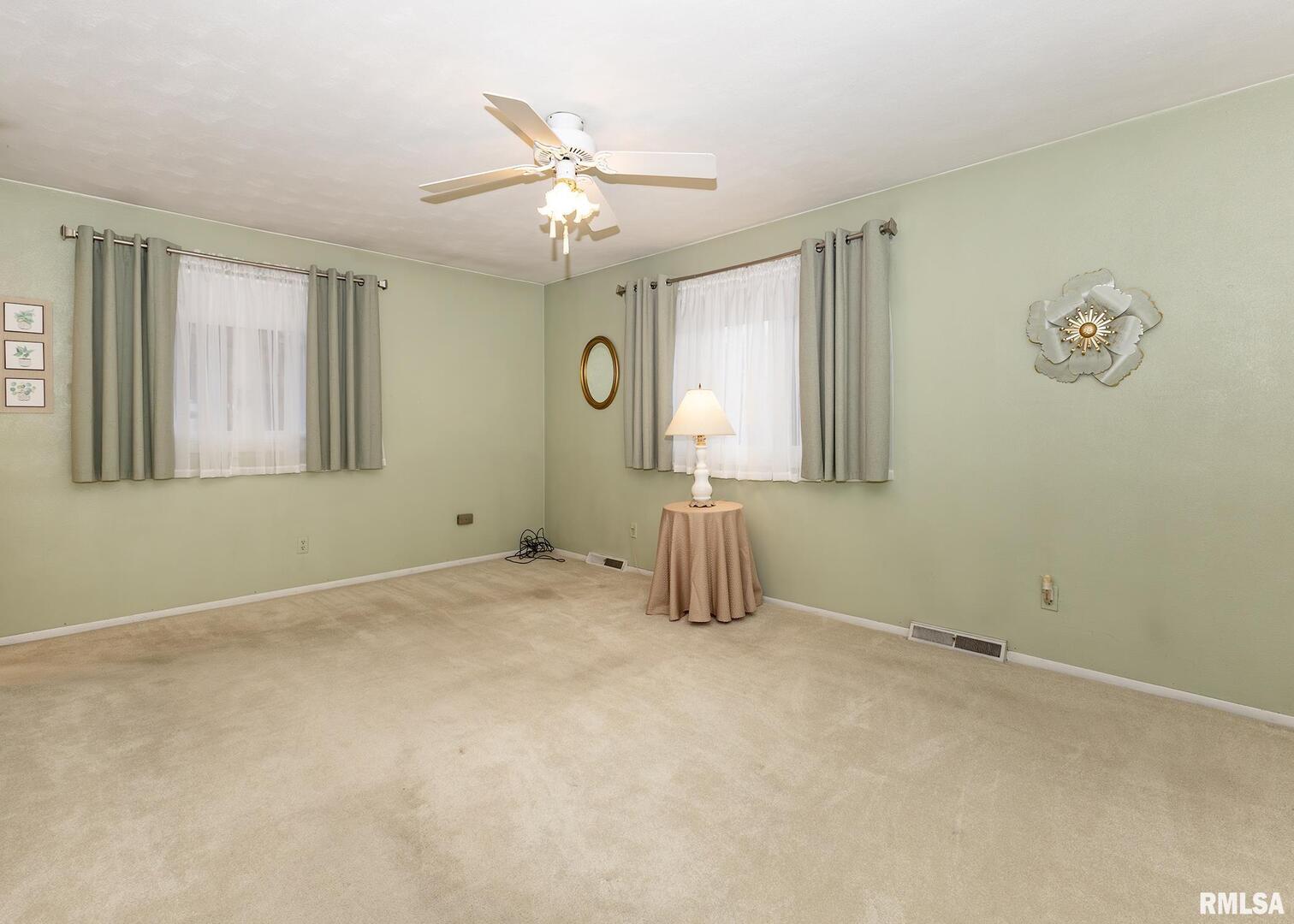 2705 36th Street Rock Island, IL 61201 - Photo 12 of 29 an empty room with windows and fan