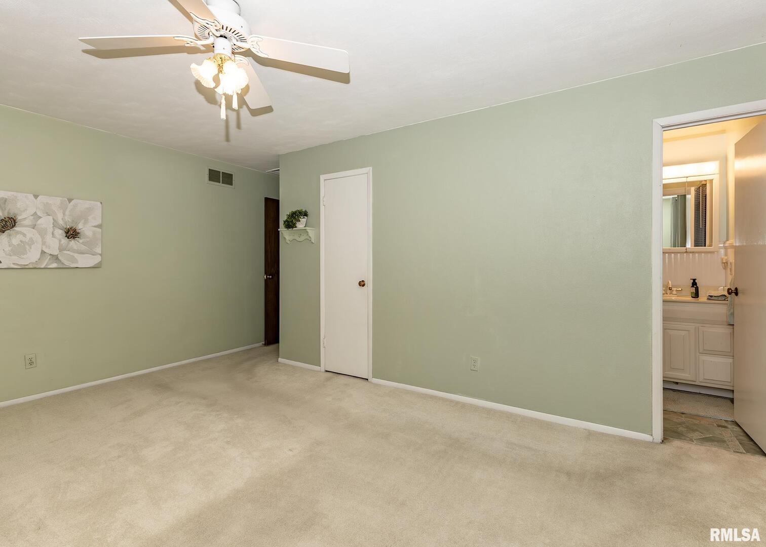 2705 36th Street Rock Island, IL 61201 - Photo 13 of 29 an empty room with a chandelier fan and closet