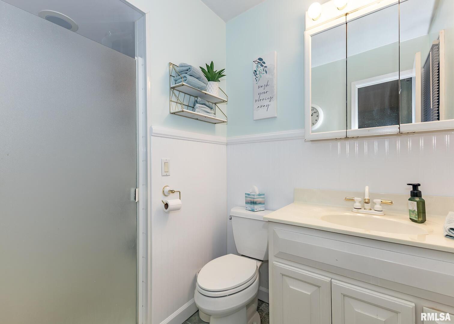 2705 36th Street Rock Island, IL 61201 - Photo 14 of 29 a bathroom with a sink a toilet and vanity